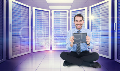 Composite image of smiling businessman showing his digital table