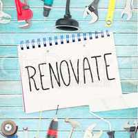 Renovate  against tools and notepad on wooden background