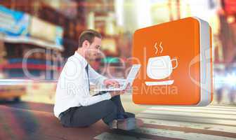 Composite image of smiling businessman sitting on floor using la