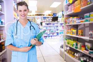 Composite image of smiling nurse holding clipboard