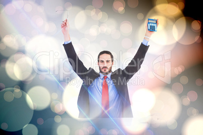 Composite image of businessman holding up reading glasses and ca