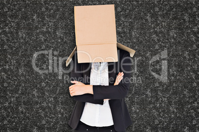 Composite image of businesswoman lifting box off head