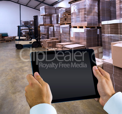 Composite image of man using tablet pc