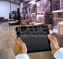 Composite image of man using tablet pc