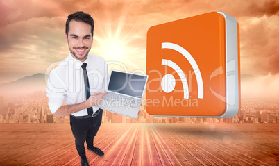 Composite image of smiling businessman pointing his laptop