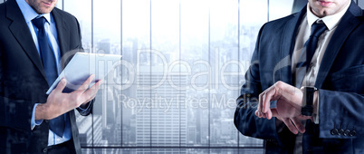 Composite image of businessman checking the time on watch