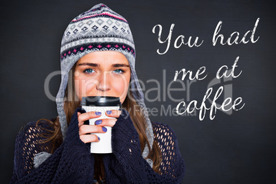 Composite image of beautiful woman in warm clothing drinking cof