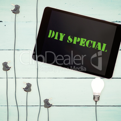 Diy special against bulbs and tablet on wooden background