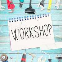 Workshop against tools and notepad on wooden background