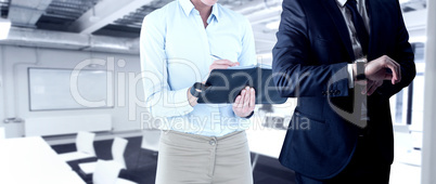 Composite image of handsome businessman checking the time