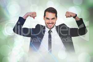 Composite image of happy businessman in suit cheering