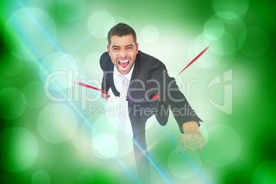 Composite image of businessman crossing the finish line