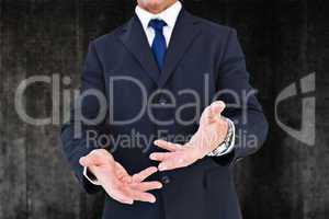 Composite image of smiling businessman in suit with arm out