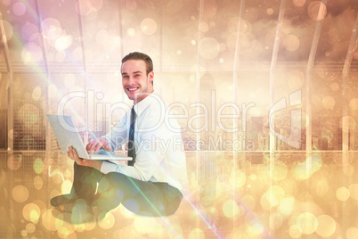 Composite image of happy businessman sitting and using laptop Composite image of happy businessman sitting and using laptop