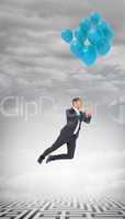Composite image of businessman flying with balloon