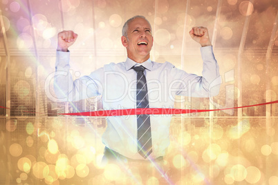 Composite image of businessman winning race