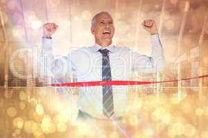 Composite image of businessman winning race