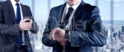 Composite image of focused businessman texting on his mobile pho