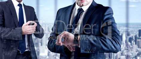 Composite image of focused businessman texting on his mobile pho