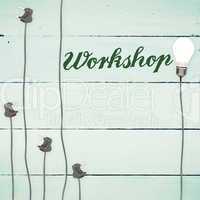 Workshop against light bulbs on wooden background