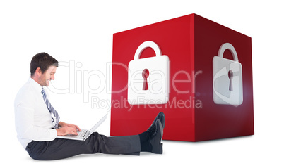 Composite image of businessman using laptop and smiling