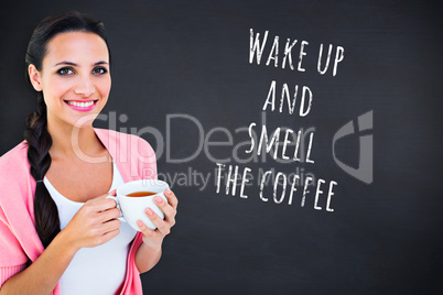 Composite image of pretty brunette holding a mug