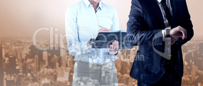 Composite image of handsome businessman checking the time