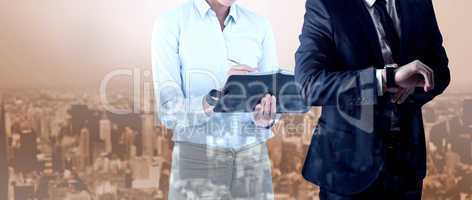 Composite image of handsome businessman checking the time