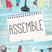 Assemble against tools and notepad on wooden background