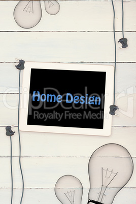 Home design against tablet and plugs on wooden background
