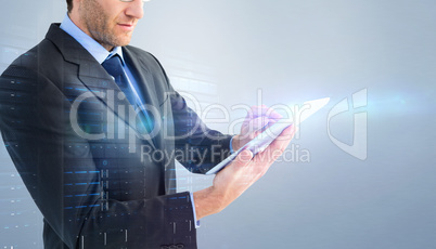 Composite image of mid section of a businessman using digital ta