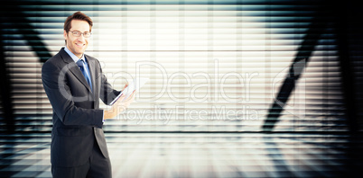 Composite image of businessman looking at the camera while using