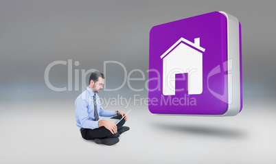 Composite image of cheerful businessman sitting on the floor usi Composite image of cheerful businessman sitting on the floor usi