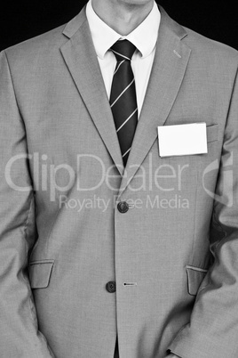 Composite image of businessman with badge