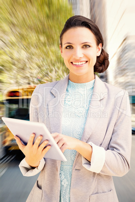 Composite image of brunette using tablet pc