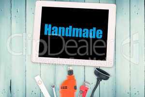 Handmade against tools and tablet on wooden background