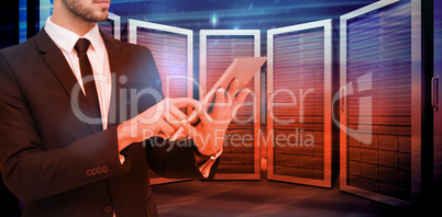 Composite image of mid section of a businessman using digital ta