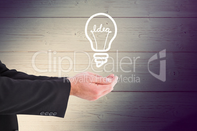 Composite image of businessman holding something with his hands