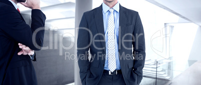 Composite image of businessman looking at the camera