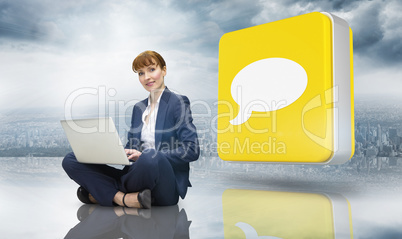 Composite image of businesswoman using laptop