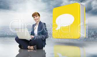 Composite image of businesswoman using laptop