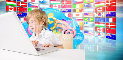 Composite image of cute boy using laptop