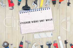 Create what you want against tools and notepad on wooden backgro