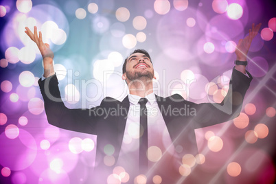 Composite image of businessman cheering with hands raised