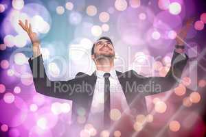 Composite image of businessman cheering with hands raised
