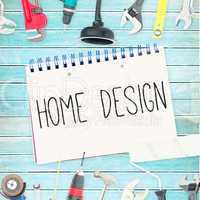 Home design against tools and notepad on wooden background
