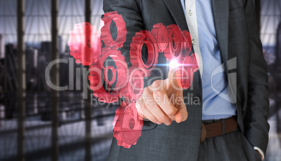 Composite image of businessman in grey suit pointing