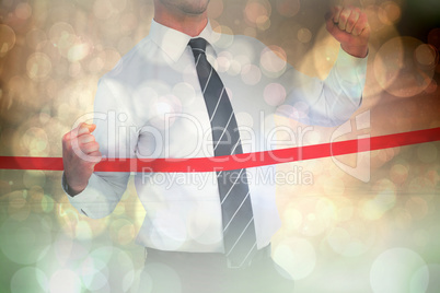 Composite image of businessman crossing the finish line Composite image of businessman crossing the finish line