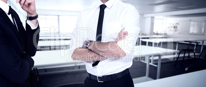 Composite image of smiling businessman with arms crossed