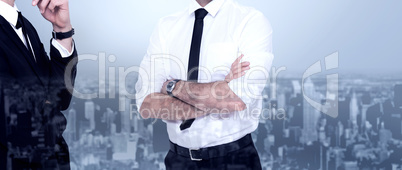 Composite image of smiling businessman with arms crossed